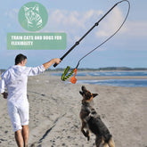 FelRelWel Flirt Pole for Dogs used by man on beach to train and play with German Shepherd